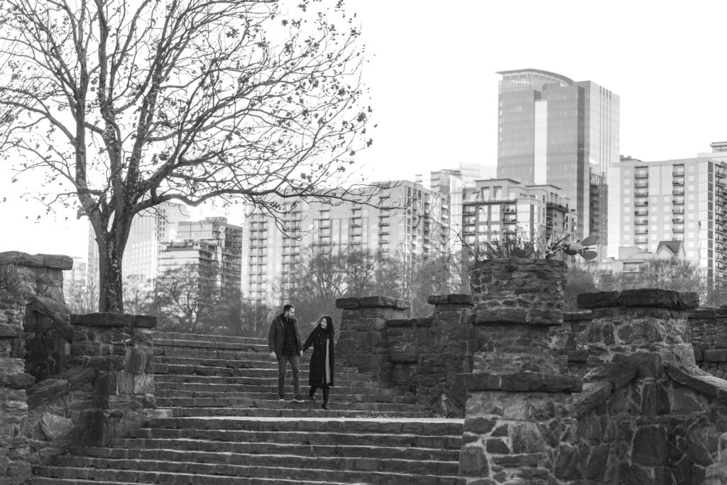 Engaged couple walks down steps in Piedmont Park - Atlanta, GA